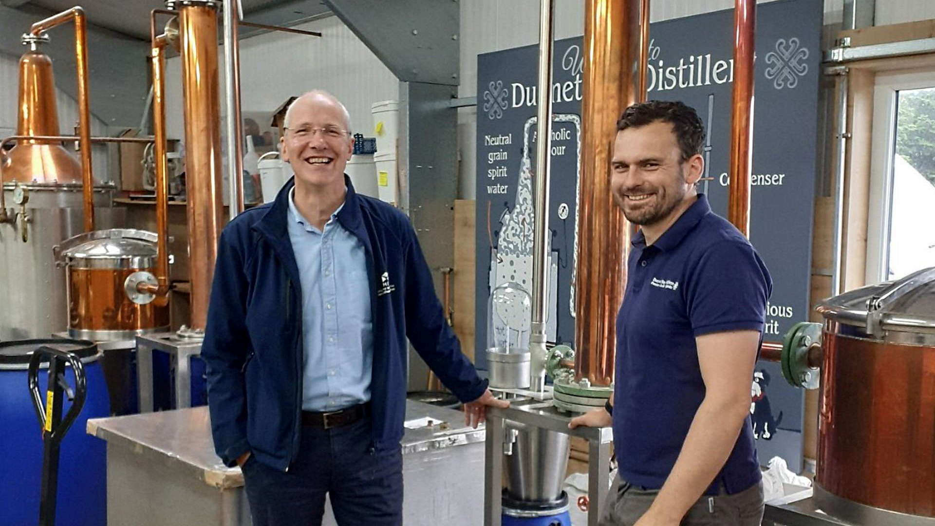 HIE CEO Stuart Black in front of a still at Dunnet Bay Distillery