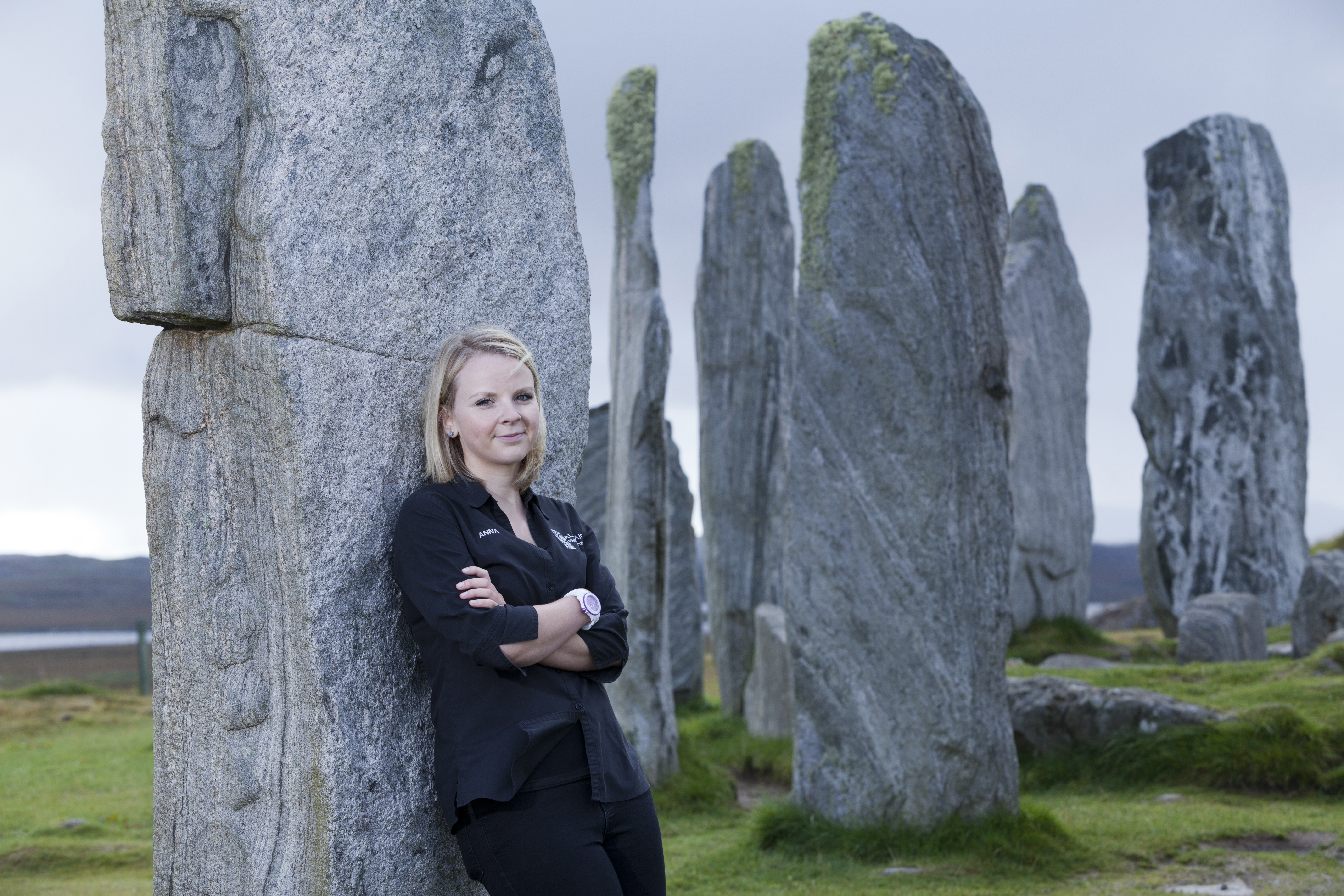 Girl standing by the famous Callanish standing stones in the outer hebrides
