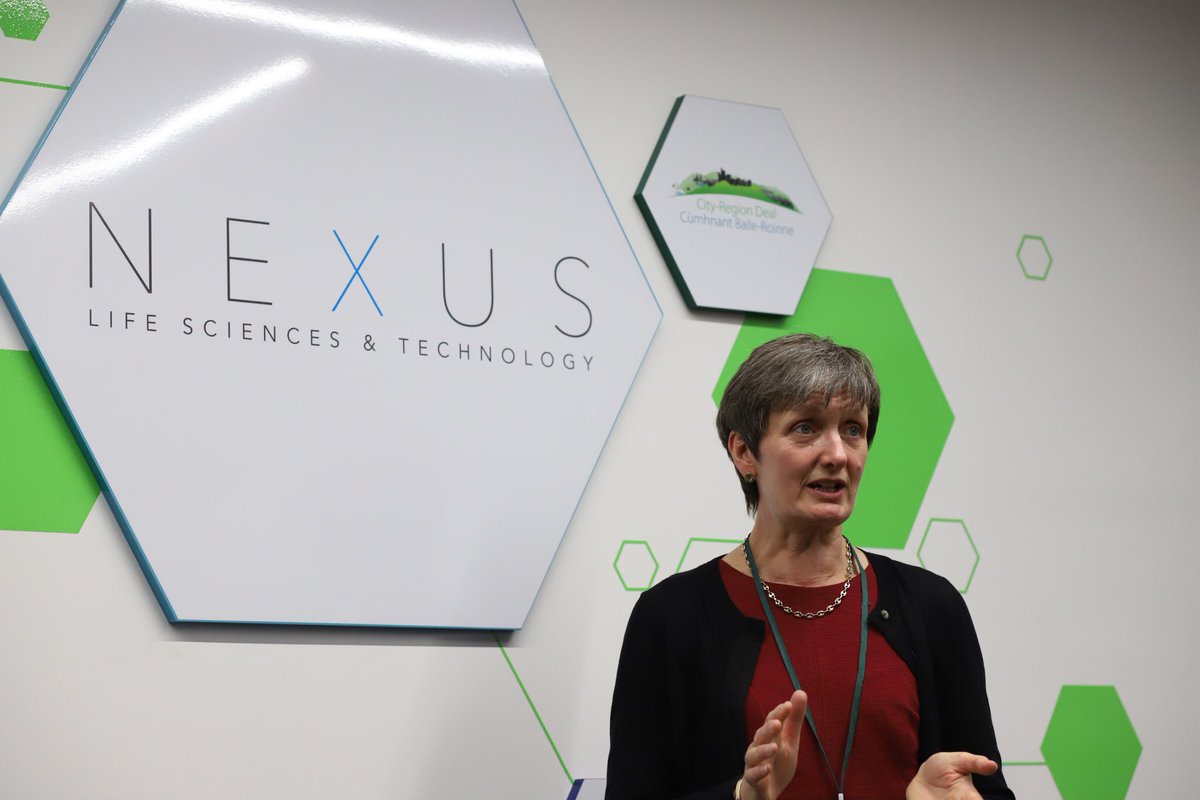 A woman speaking at the opening of an event 