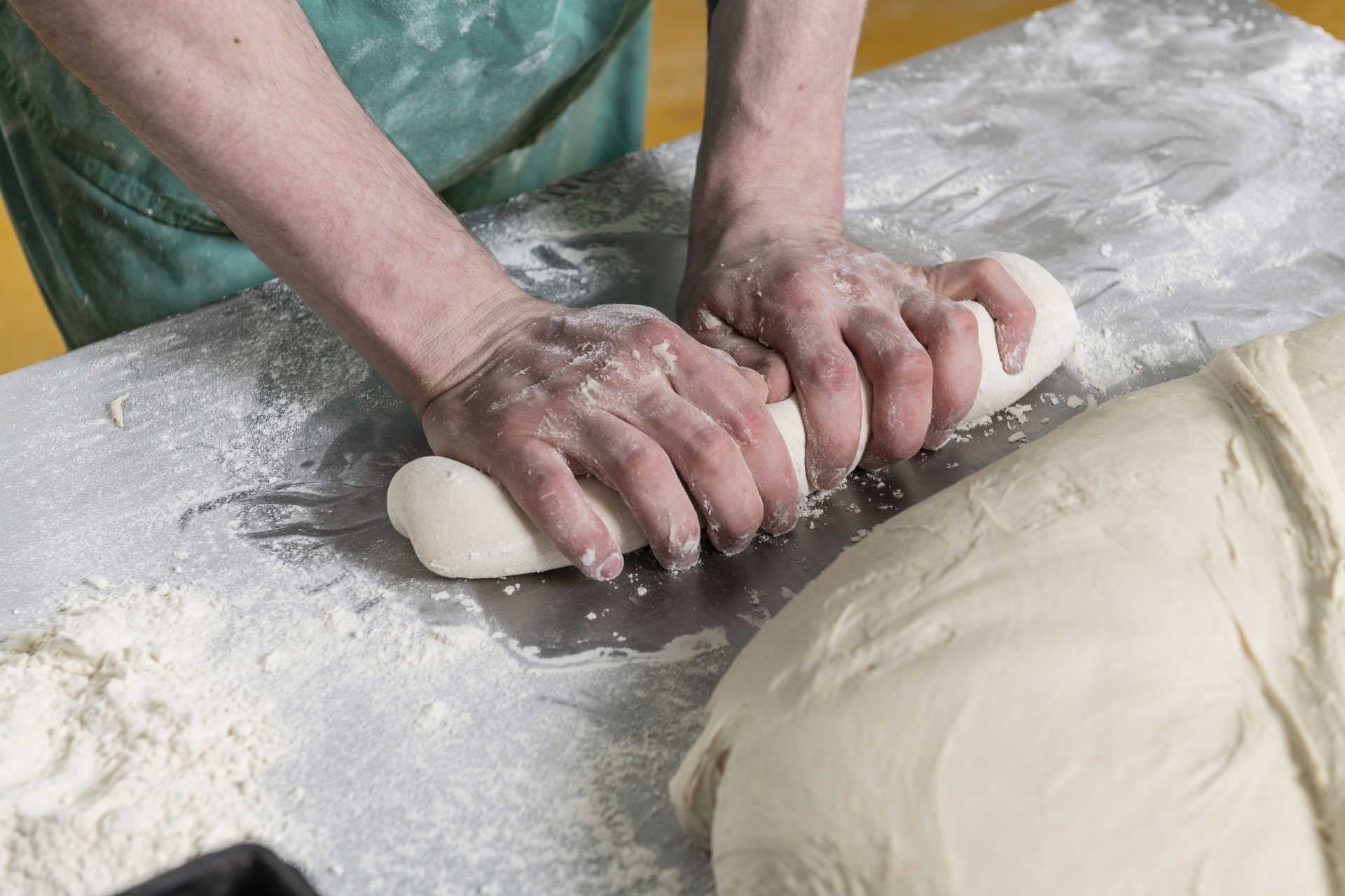 Baker preparing dough at Maclean's Highland Bakery, Forres,