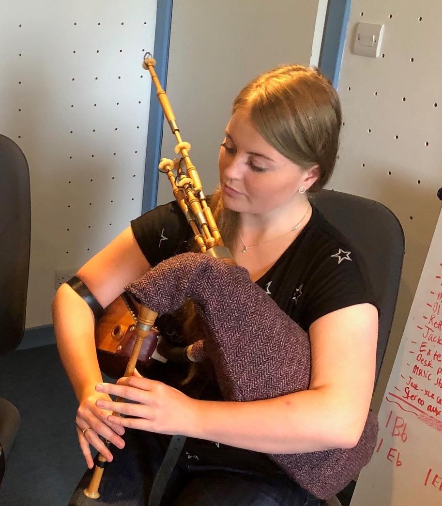 Musician Chloe Steele playing a traditional instrument