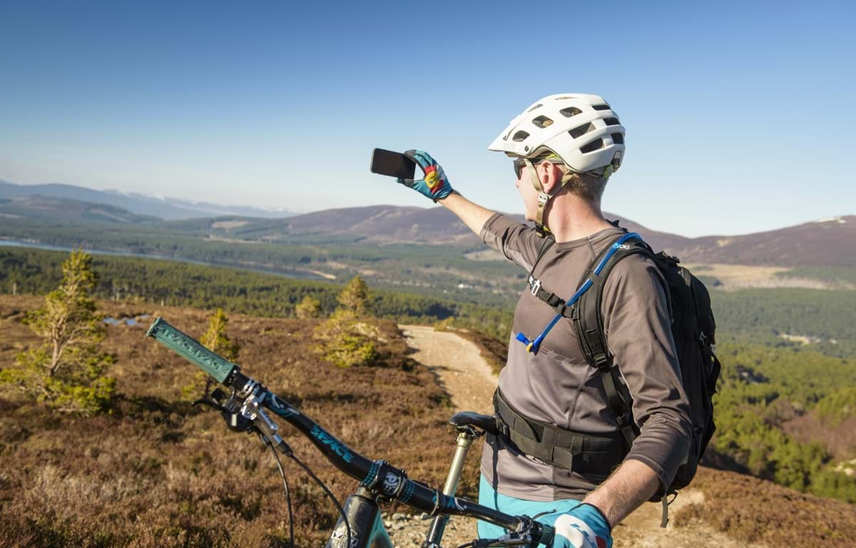 Man mountain biking through Cairnforms national park