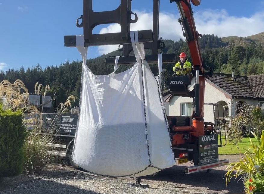 A digger lifting an Easy Empty Bag