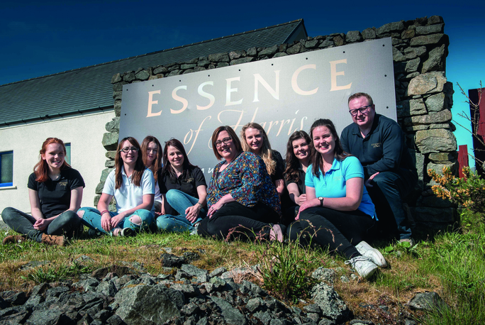 staff from Essence of Harries in front of company sign