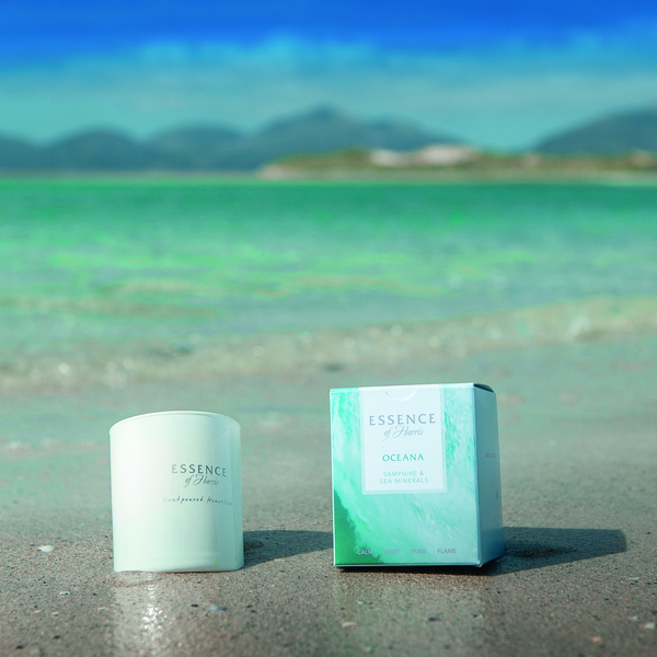 Essence of Harris scented products sitting on white sand beach
