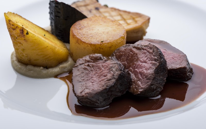 Plate of roast venison with vegatables